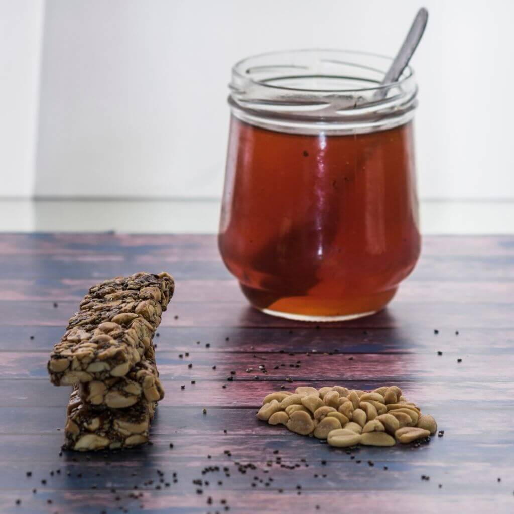 Honey and Almond Granola Bars, a stack of chewy bars with visible almonds and a drizzle of honey.