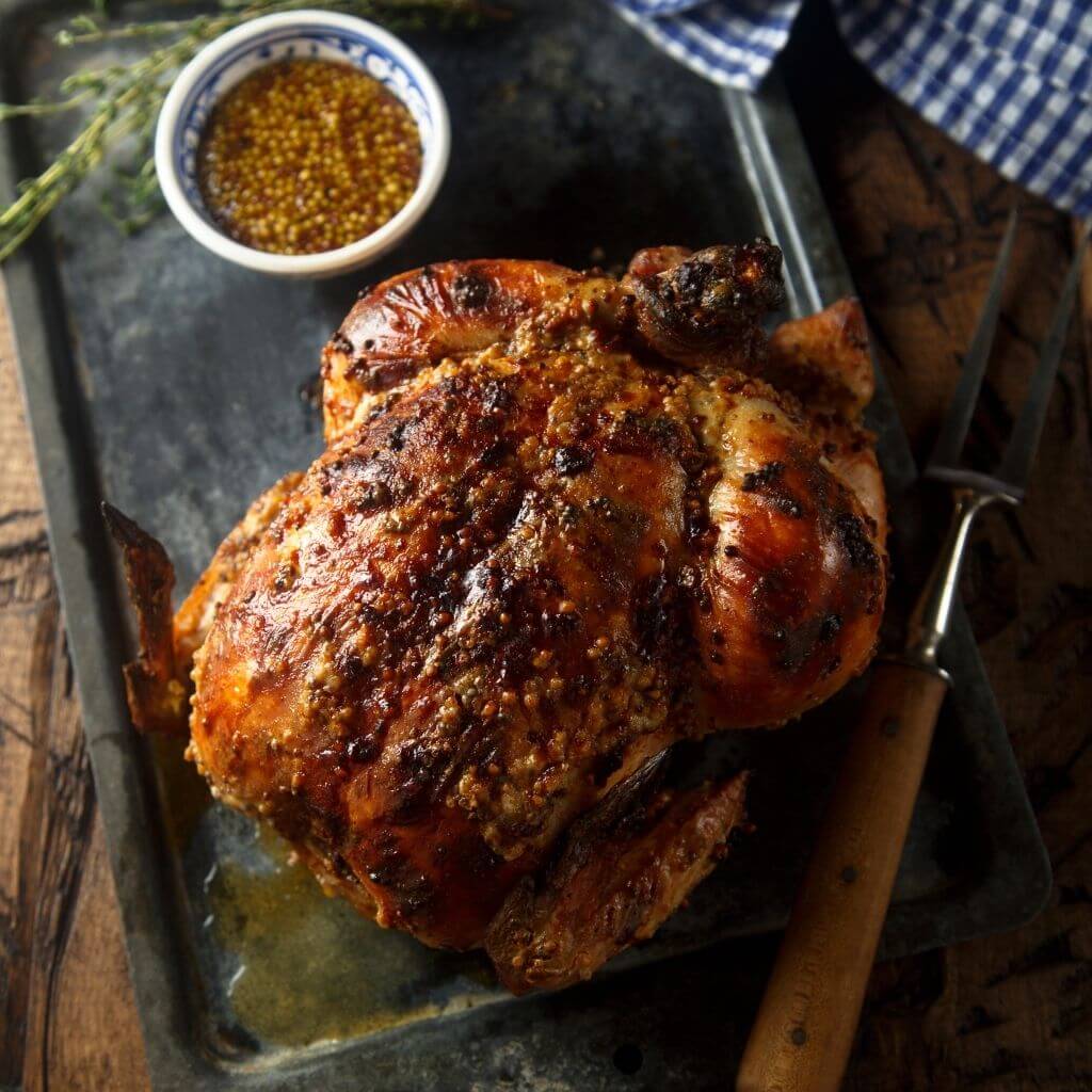 Honey and Balsamic Glazed Chicken, succulent chicken breast with a sweet and tangy glaze, garnished with herbs.