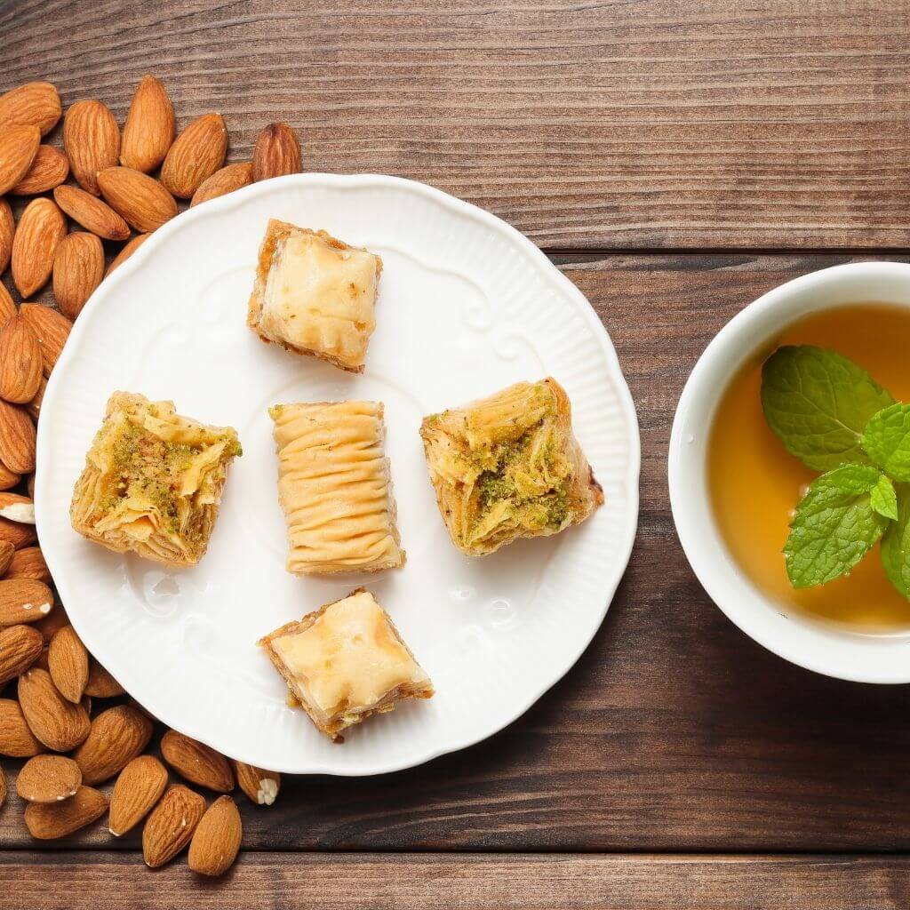 Honey and Almond Baklava, a stack of flaky pastry layers filled with almonds and sweetened with honey syrup.