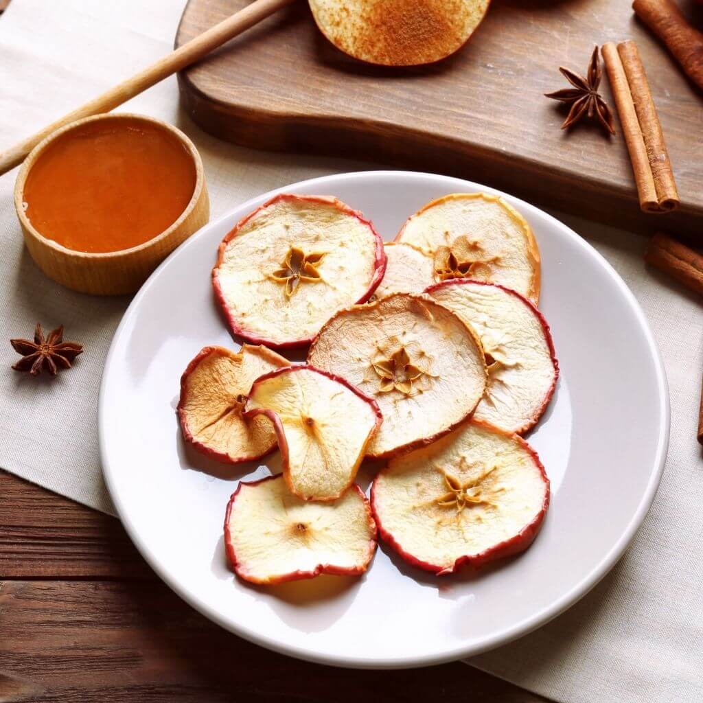 Honey and Cinnamon Apple Chips, crispy apple slices drizzled with honey and dusted with cinnamon.
