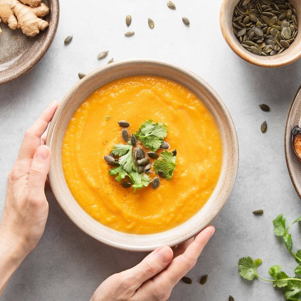 Honey-Roasted Butternut Squash Soup, a velvety bowl of soup with a rich blend of roasted butternut squash, drizzled with honey.